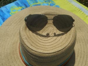 sunglasses atop a sun hat