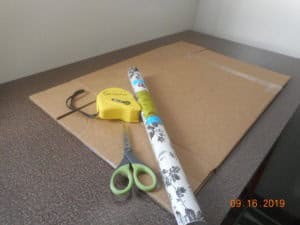 large box contact paper roll scissors and measuring tape.