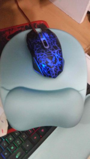 Mouse on mouse pad green and lighted blue muse