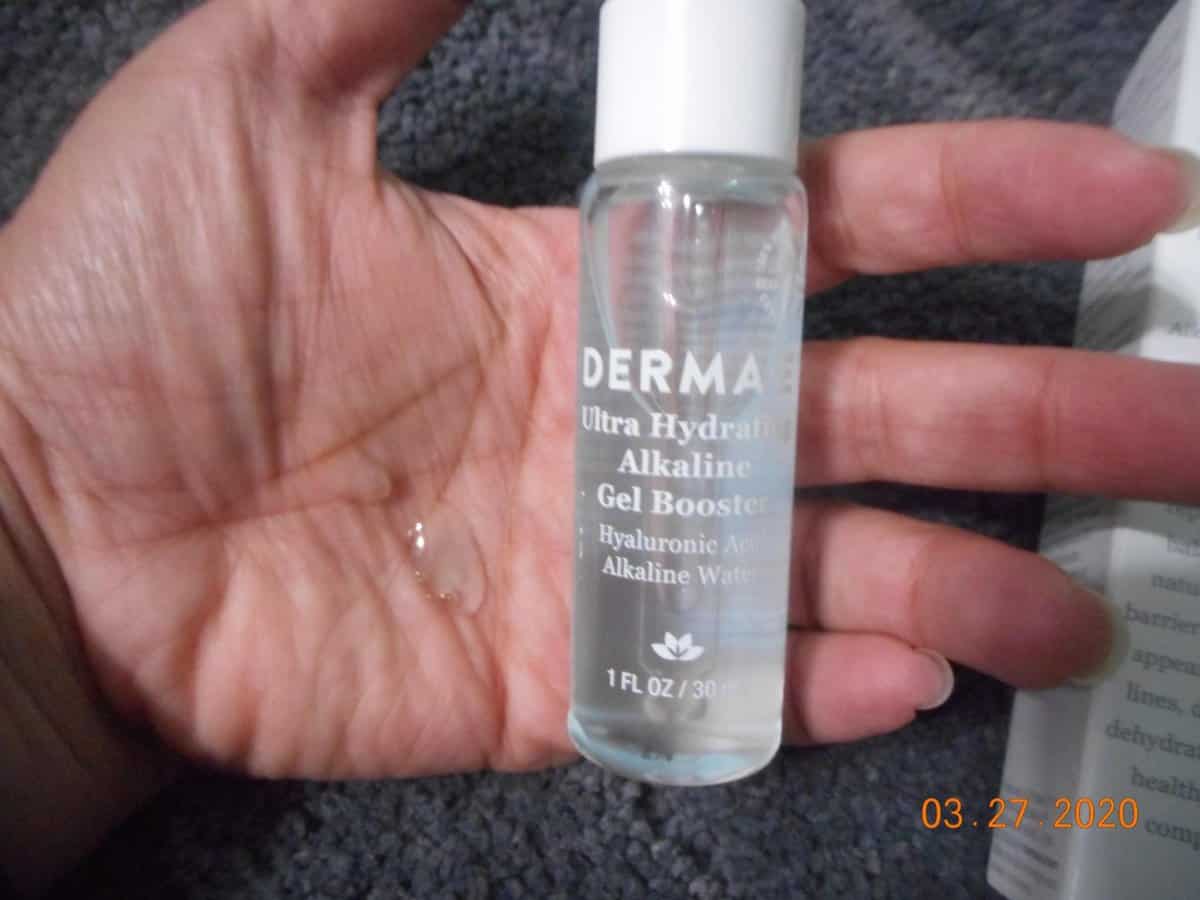 Ultra Hydrating Alkaline Gel Booster in hand with bottle