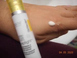 Peptight Tightening & Brightening Face Serum dot on hand with bottle