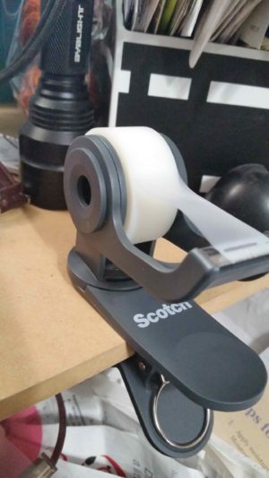 Scotch Clip & Twist Tape Dispenser clamped to shelf side view