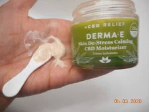 Derma-E Skin De-stress calming CBD moisturizer open jar moisturizer on spatula in my hand