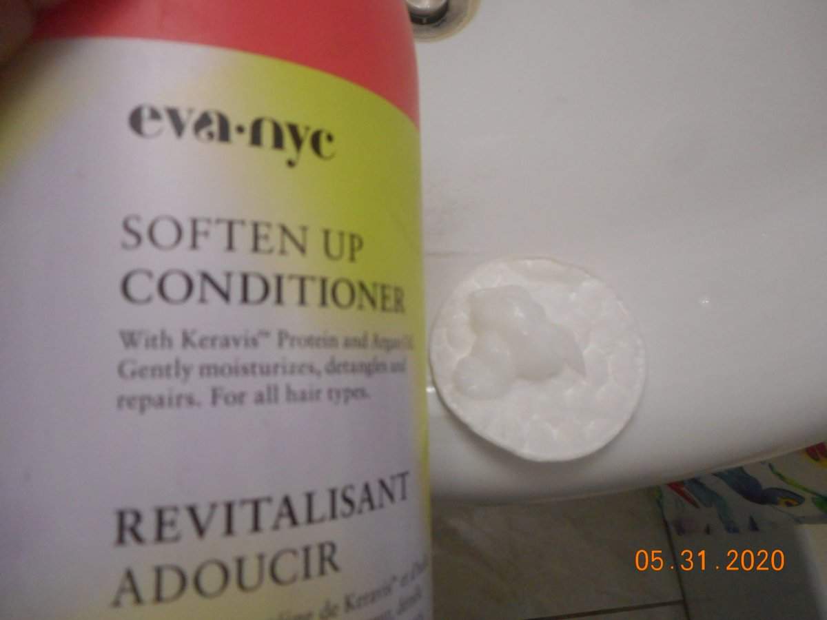 Soften Up Conditioner bottle with conditioner on a cotton pad