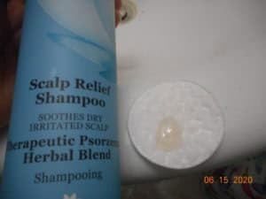 Derma-E Scalp relief shampoo with shampoo on a cotton pad