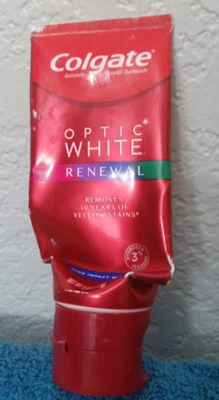 Colgate Optic White Renewal toothpaste tube empty