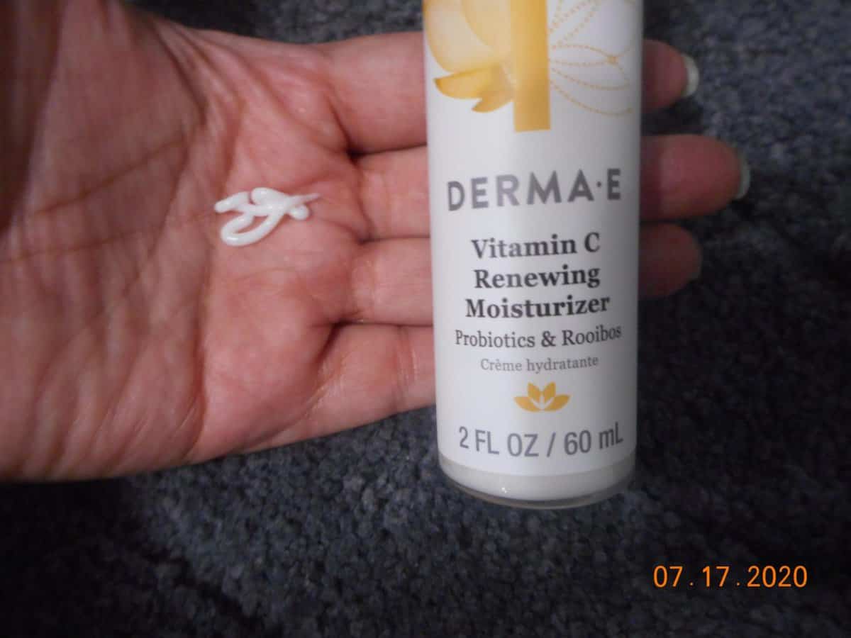 Derma-E Vitamin C renewing moisturizer in my hand. bottle resting on my fingers.