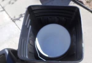 a small bucket inside the trash can base to show another trashcan can be used inside the base.