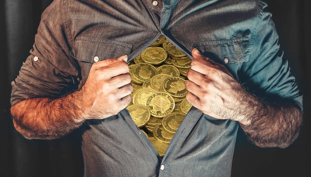 man opening his shirt. Shirt contains coins.