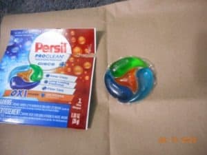 Persil pro clean discs oxi package sample with disc next to it.