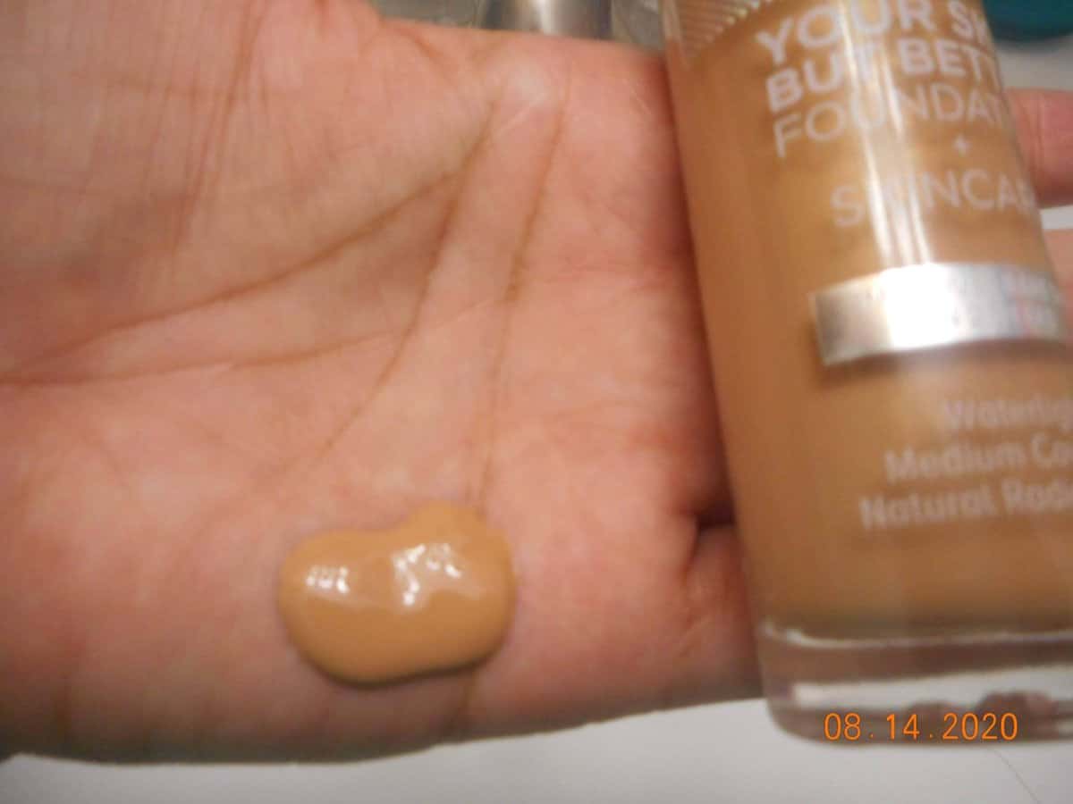 Your Skin But Better Foundation + Skincare bottle shade Tan Neutral 42. foundation in my hand.