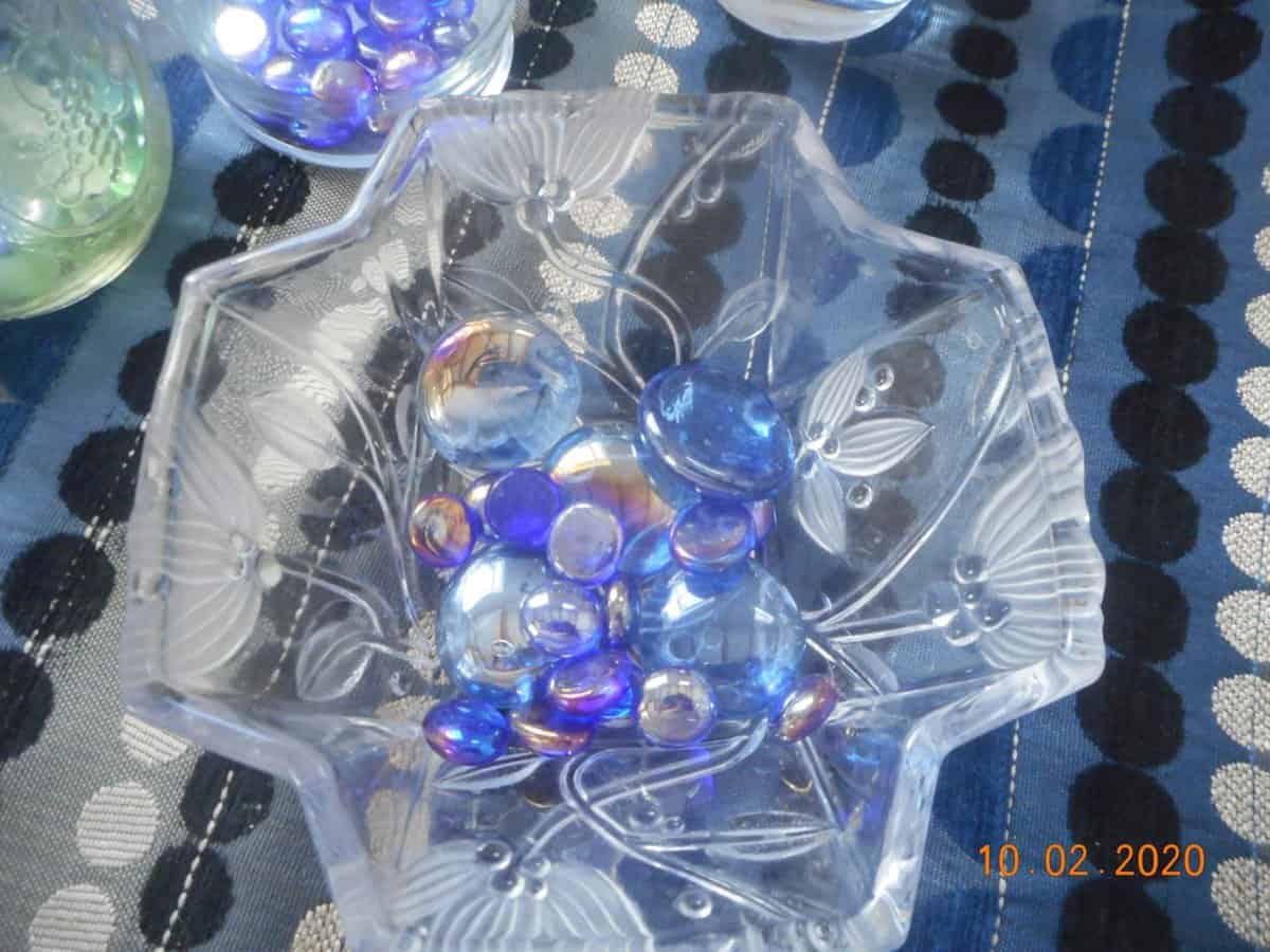 top view of glass stones in glass dish. Stones are blue and iridescent.