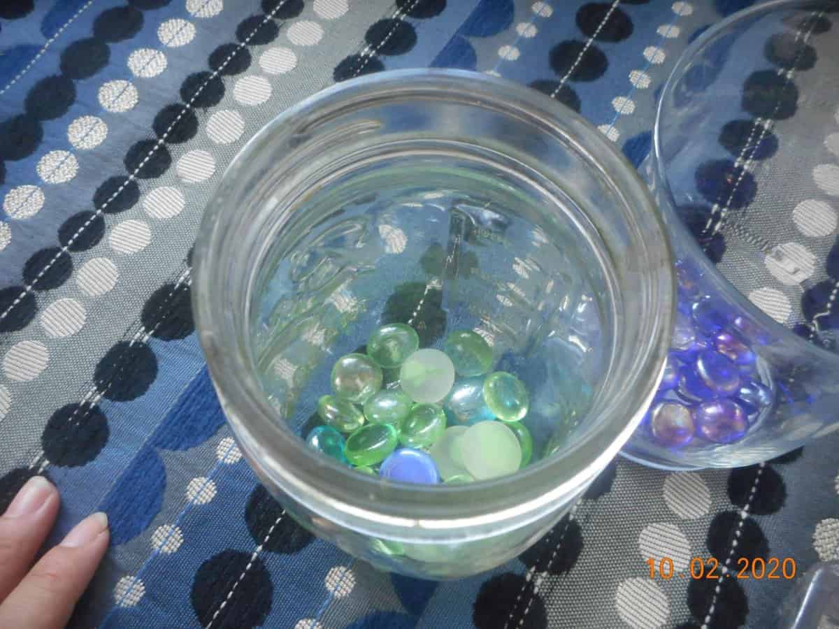 top view of glass stones in jar. green glass stones.