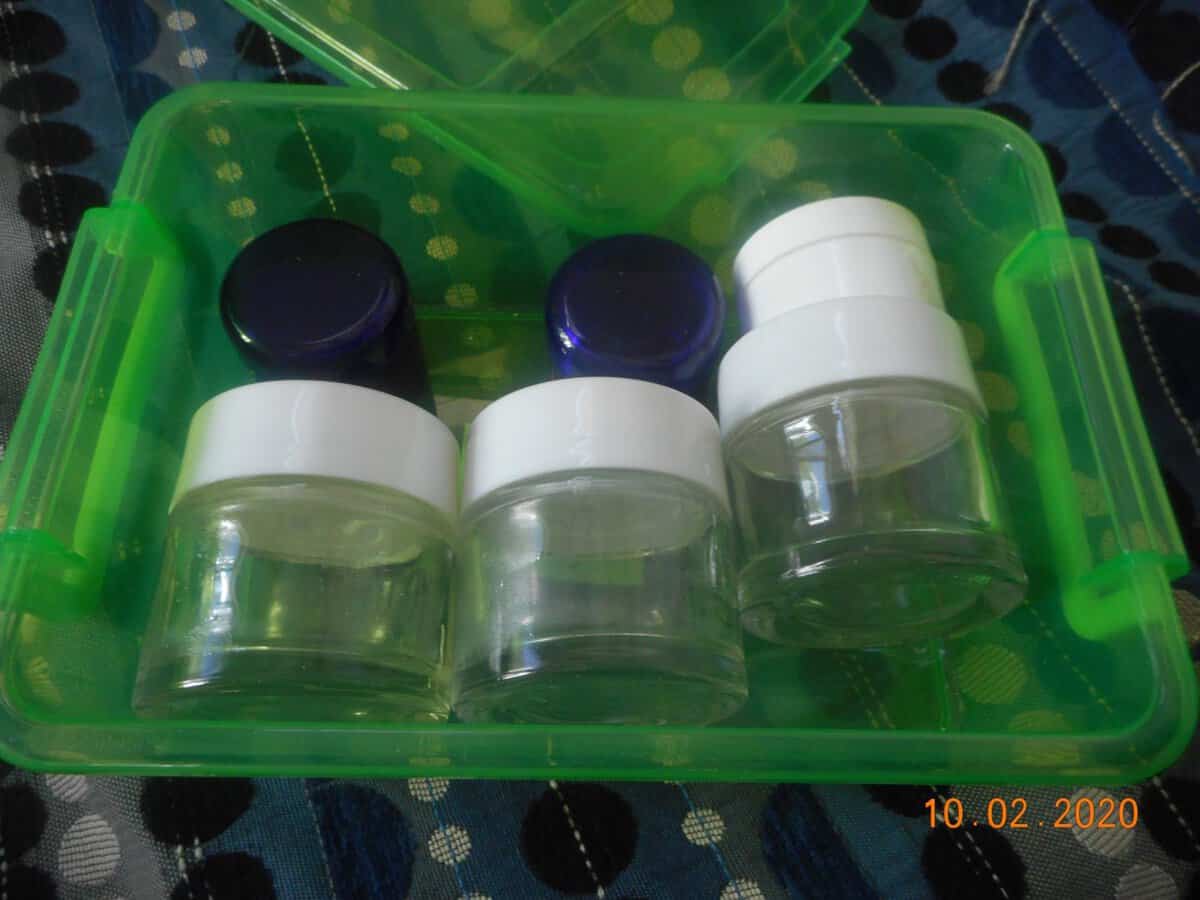 empty skincare jars glss and plastic. clear, solid plastic or dark blue.