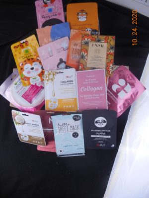 Sheet masks of various types in and around a box.