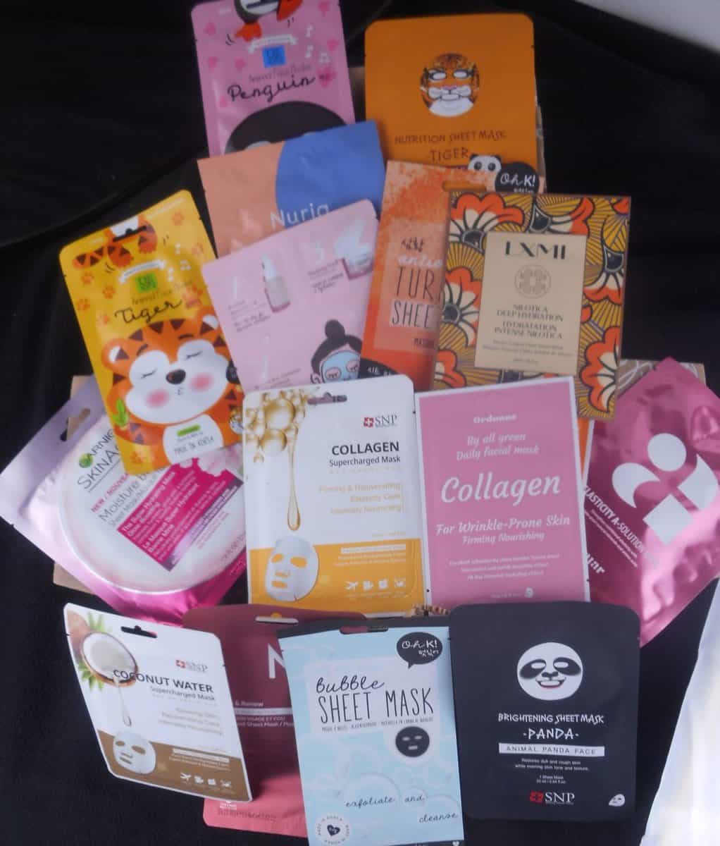 Sheet masks of various types in and around a box.