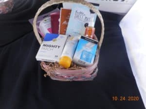 a small basket filled with skincare products. a cleanser, face serum, face oil, blemish treatment, and sheet masks.