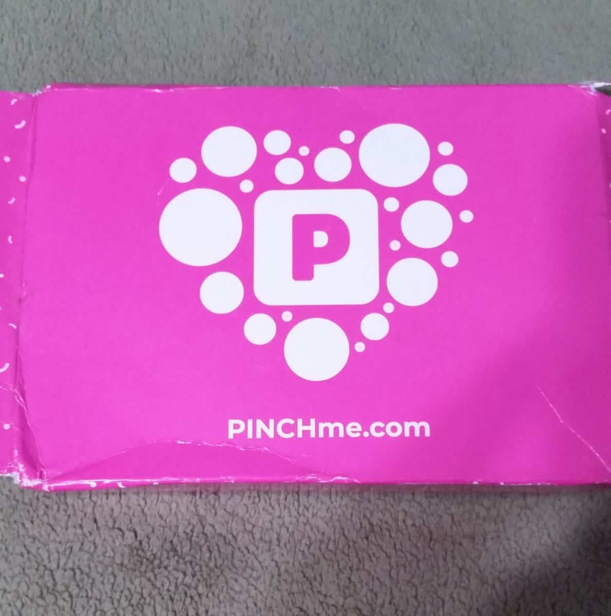 pinchme box. pink box with white bubles and square with a pink P in the center.