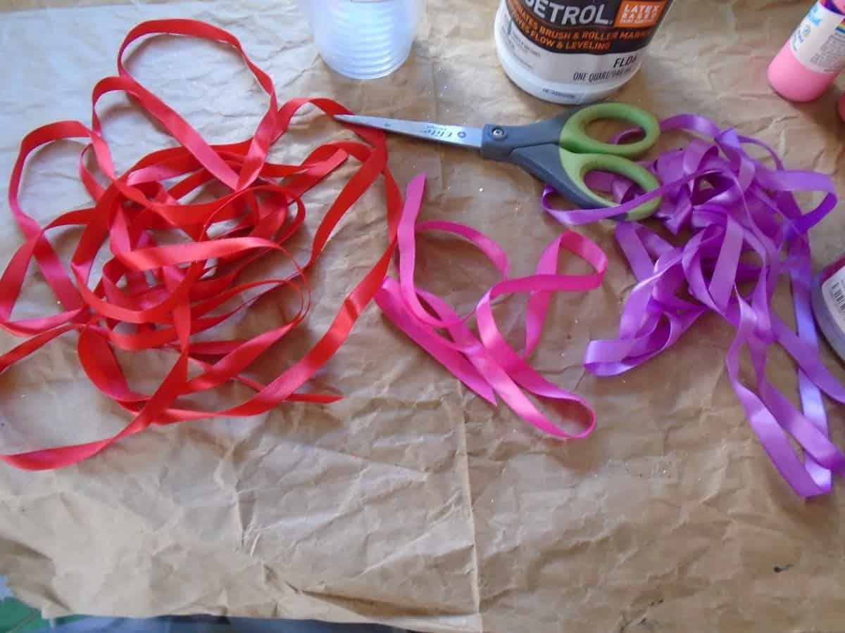 red, pink and purple ribbon with scissors.