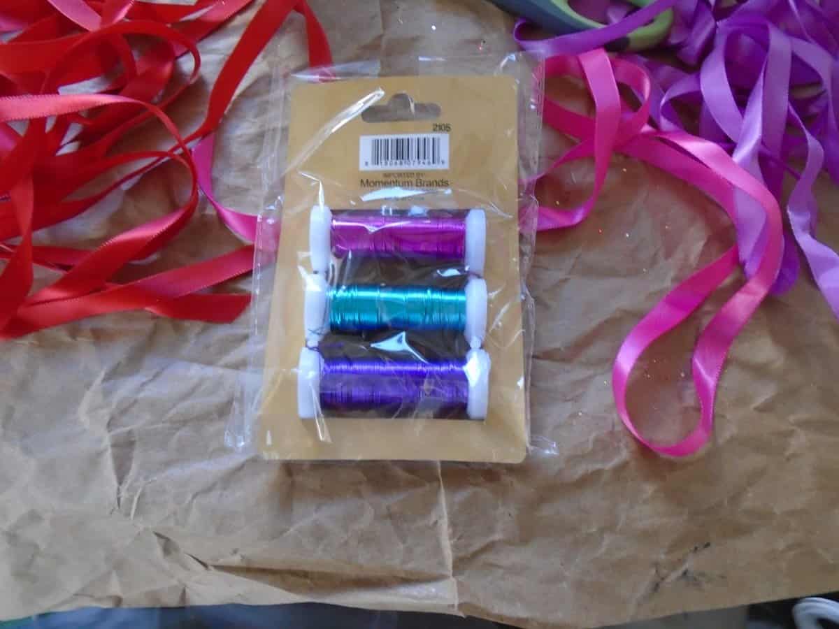 craft wire and ribgion. purple, teal and blue craft wire. red, pink and purpble ribbon.