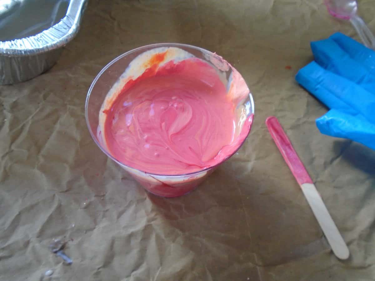 paint mixed with flood floetrol in a plastic cup.