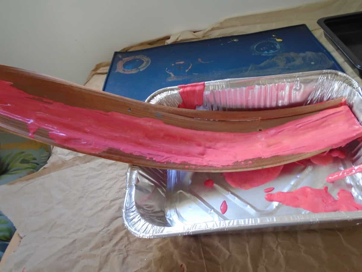 Paint pouring palm bark. Pink shade of paint.