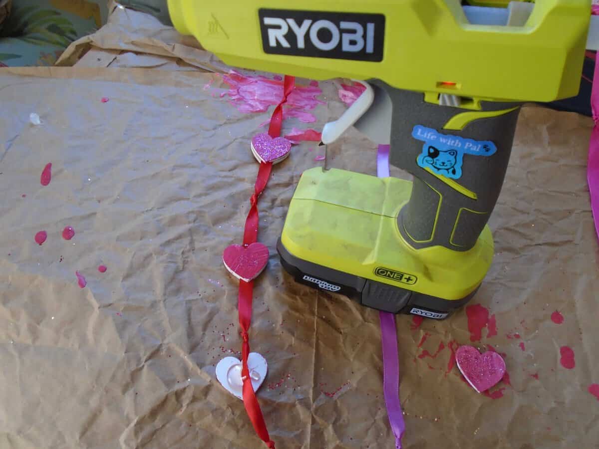 ryobi glue gun with heatts attached to ribbon. One heatr with glue on it.