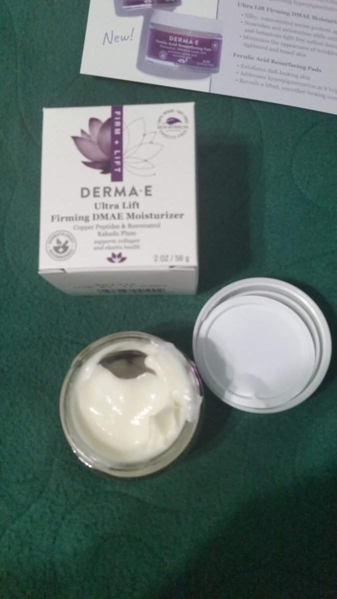 Ultra Lift Firming DMAE Moisturizer. Jar lid removed moisturizer is a cream shade.