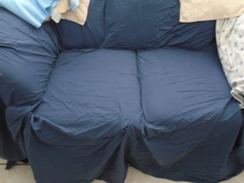 blue sheet covering a sofa. Navy blue sheet.