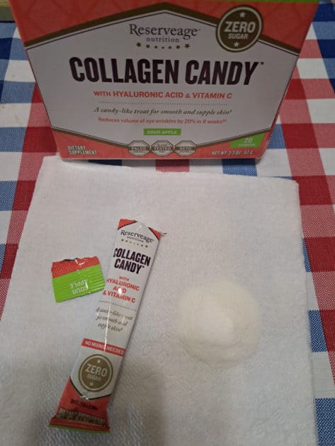 Rseerveage nutrition collagen candy box with packet and powder on a napkin.