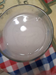 Collagen Candy mixed into a glass of water top view.