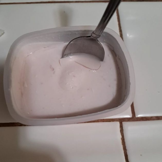 Icelandic provisions skyr yogurt with spoon in the container.