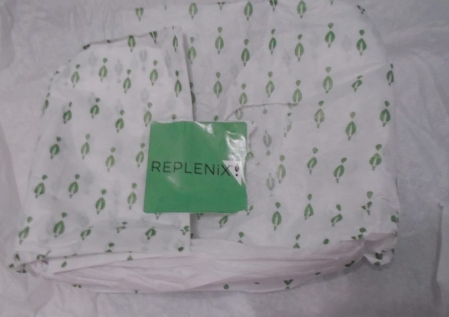 replenix branded tissue paper with a brand sticker.