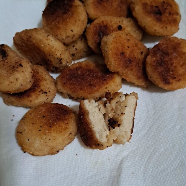 quorn meatless nuggets. cooked. one nugget cut in half.