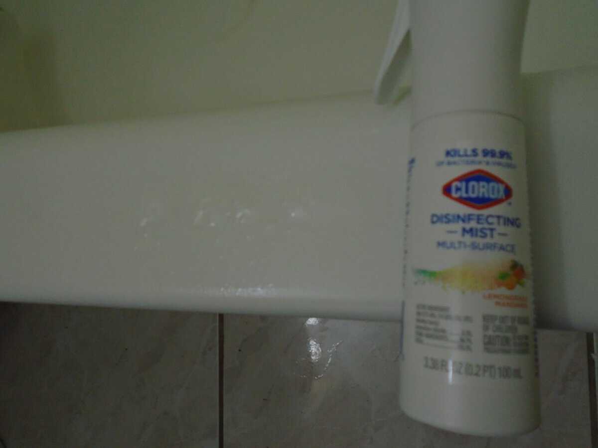 Clorox disinfecting mist bottle next to a line of product on my tub edge.