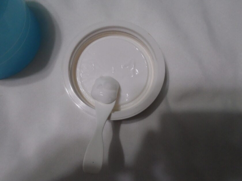 elf holy hydration cream on spatula. Cream is a white shade.