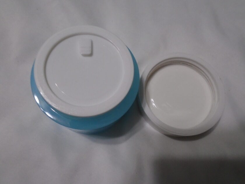 elf holy hydration cream jar with lid removed. Protective seal displayed.