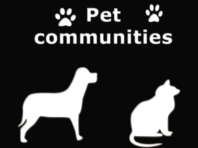 Pet communities banner. Black baground with white text. Pet communities with white paws on either side of the text. a dog and cat icon below this in white.