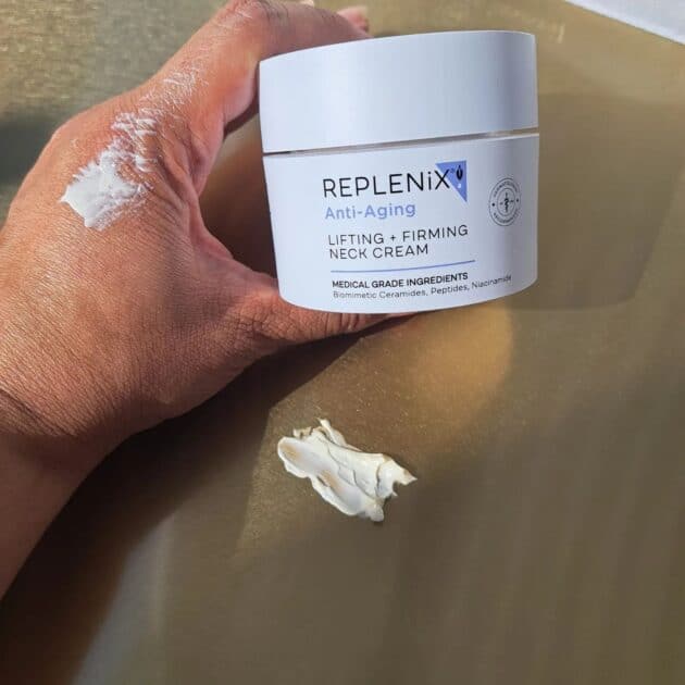 replenix LIFTING + FIRMING NECK CREAM jar Lid on with two swatches. one on my hand and another on a mat.