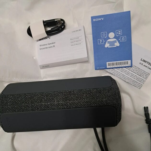 sony SRS XE-200 speaker with charging cable and info sheets.