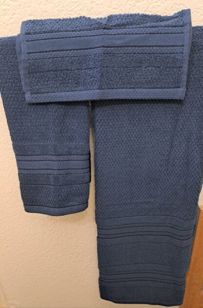 Bath towels on a rack. navy blue towels.