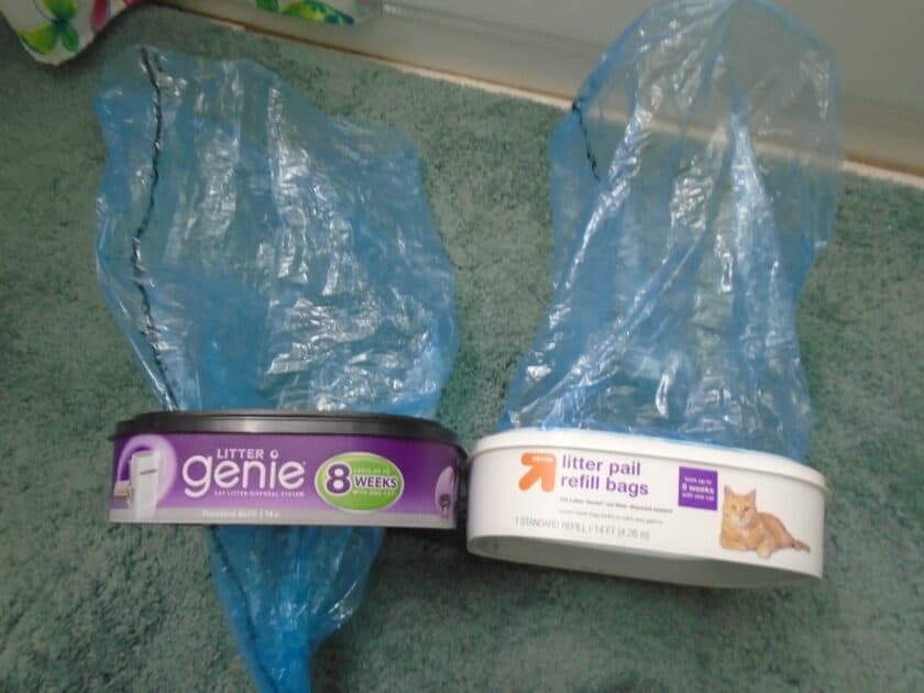 Litter genie and up and up litter pail refills containers. with bags extended from each one.