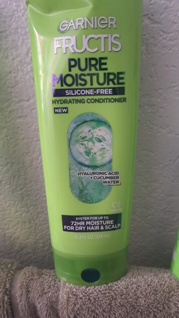 Garnier fructis pure moisture conditoner bottle. in natural light. Bright green bottle.