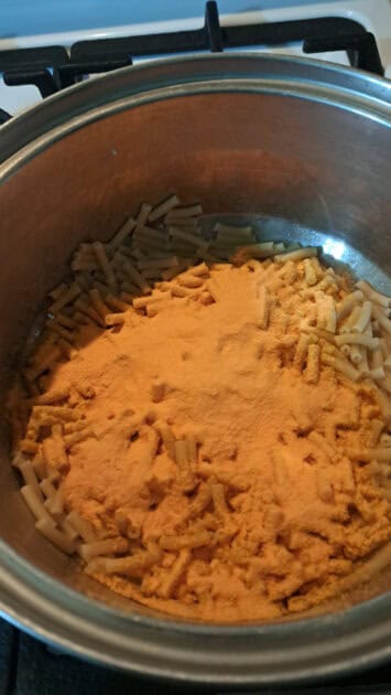 Cheese powder added to cooked pasta.