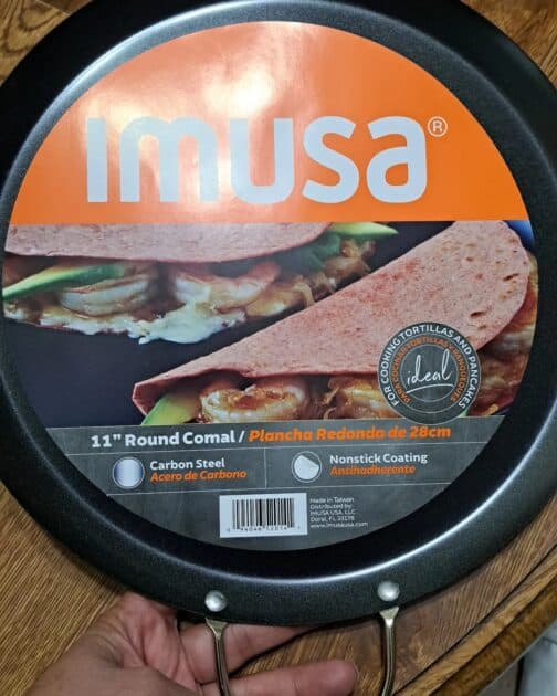 Imusa 11 inch round comal with info paper attached to it.