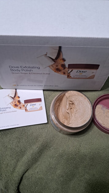 Dove exfoliating body polish brown sugar & coconut butter jar lid removed with info card and box.