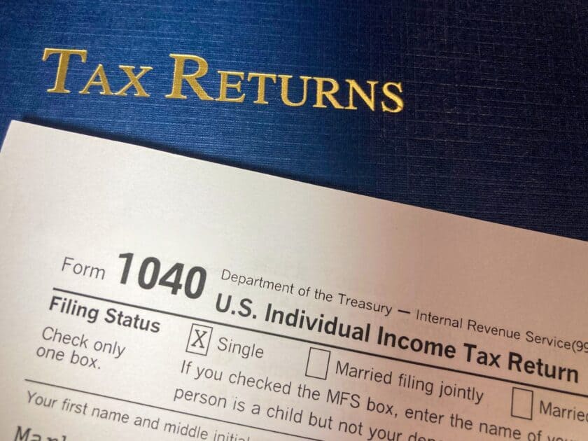 Tax Returns with Portfolio, IRS form 1040. Photo source pexels dot com. Photo by Mark Youso.