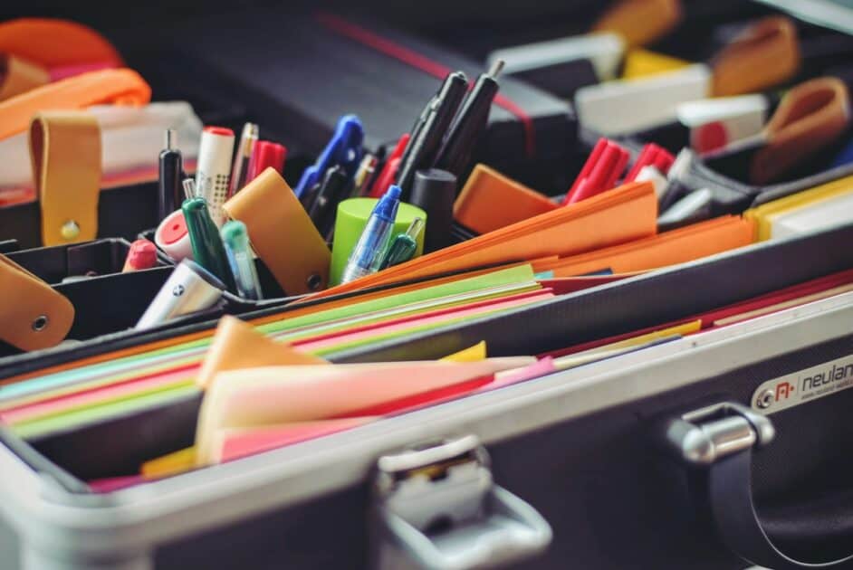 assorted pen and colored papers in organizer case. Photo by Tim Gouw. Image source from Unsplash.