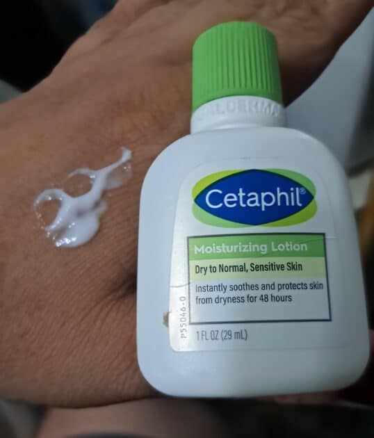 Cetaphil loiton (white) on my (V) hand. Travel size citaphil lotion bittoe next to the product.