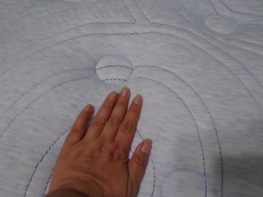 Serta perfect sleeper Bleu moments mattress pattern. hand placed on mattress to show give.